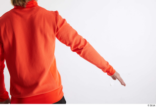 Erling  1 arm back view dressed flexing orange long…